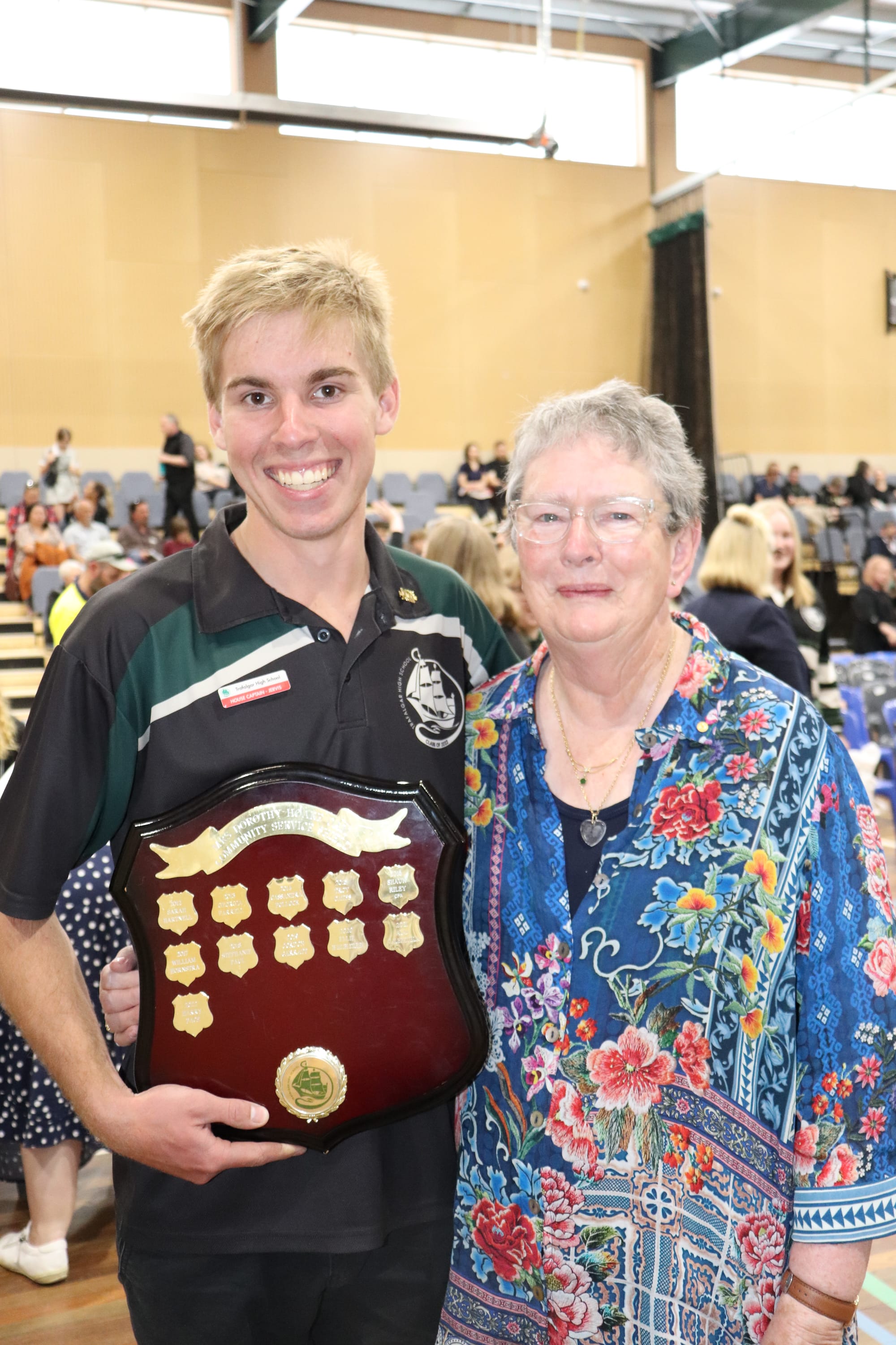 Dorothy Hoare (right) congratulates student Harry Pace on receiving her Community Service Shield for 2022.