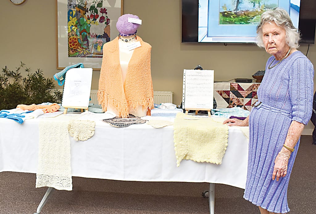 Nance Black shows off her collection of works, including knitting, crocheting, and a collection of short stories.