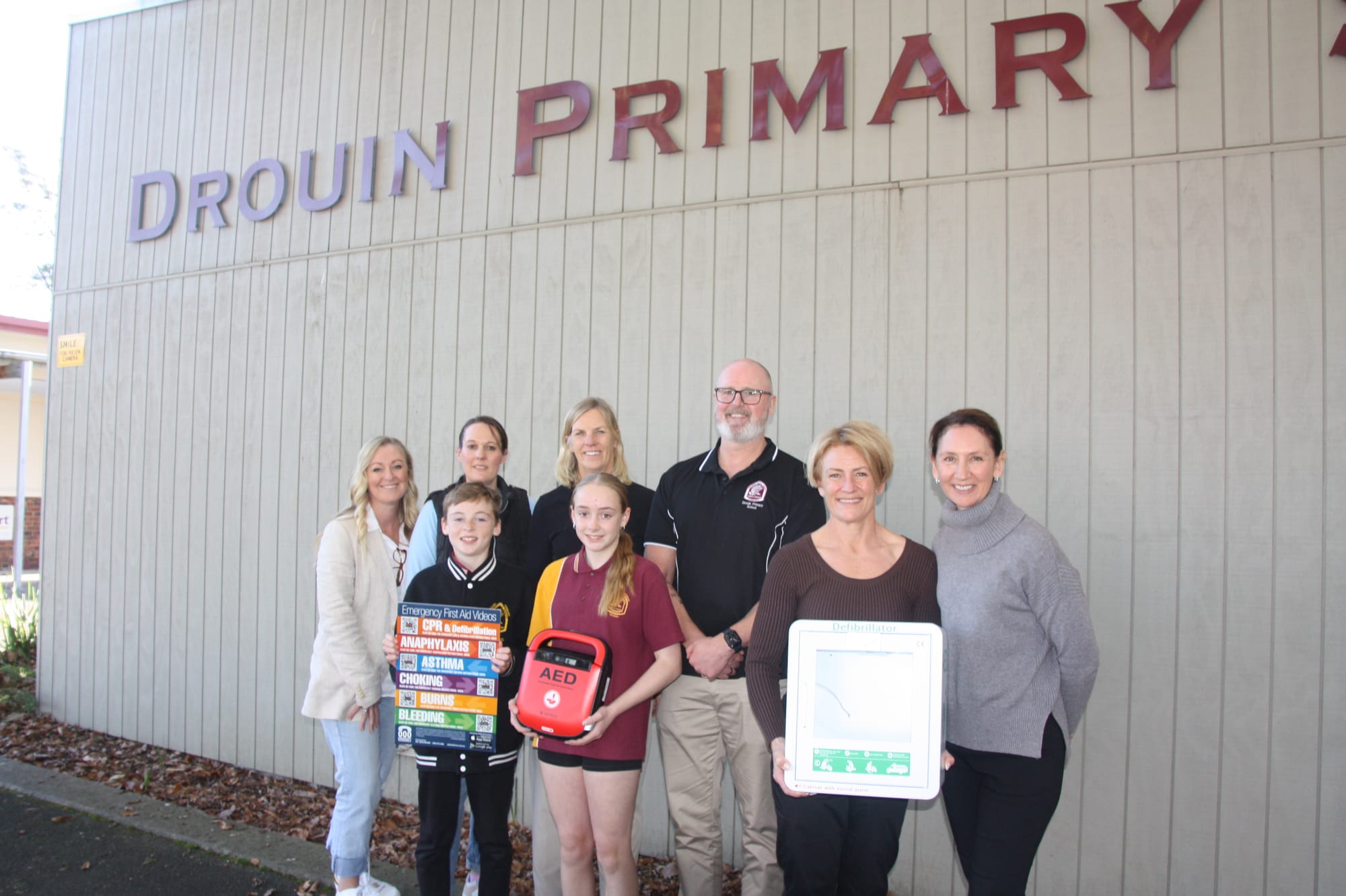 At Drouin Primary School for the presentation are AGDO committee member Nina McMahon, school first aid officer Laura, Jax, Sophie, Cornelissen, Katherine Lehmann, principal Brad Wheller, and committee members Jeanette Radford and Angela Kriesl.