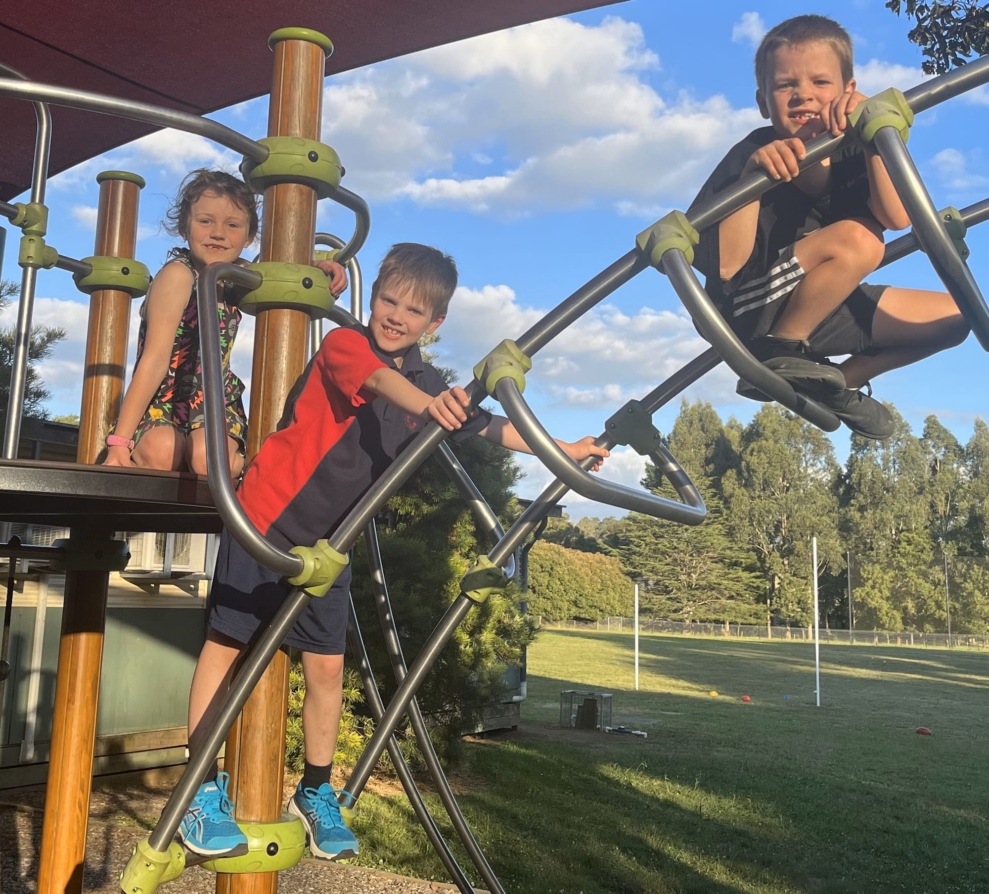 Grade two students Skylar, Darcy and Archie are active on the adventure playground.