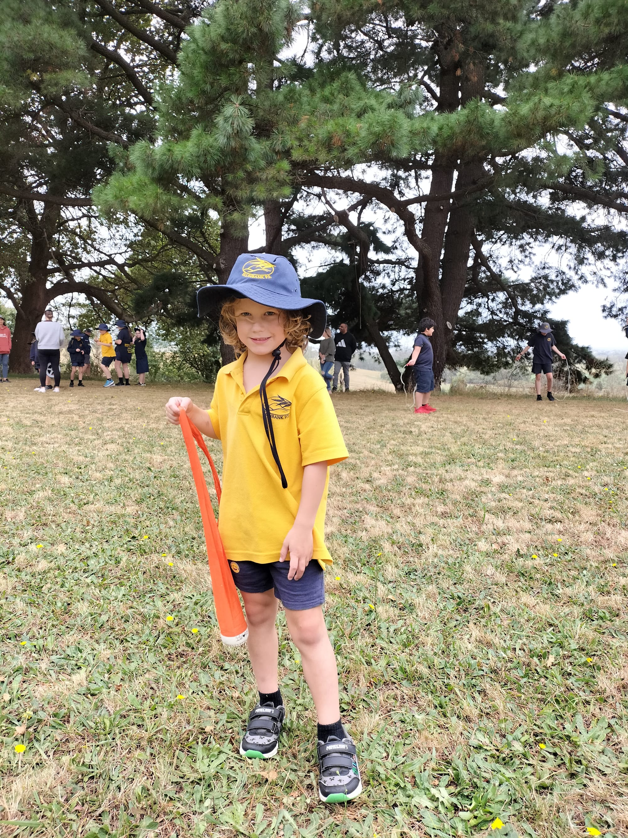 Grade one student Elijah Saward prepares for the novelty shotput event.