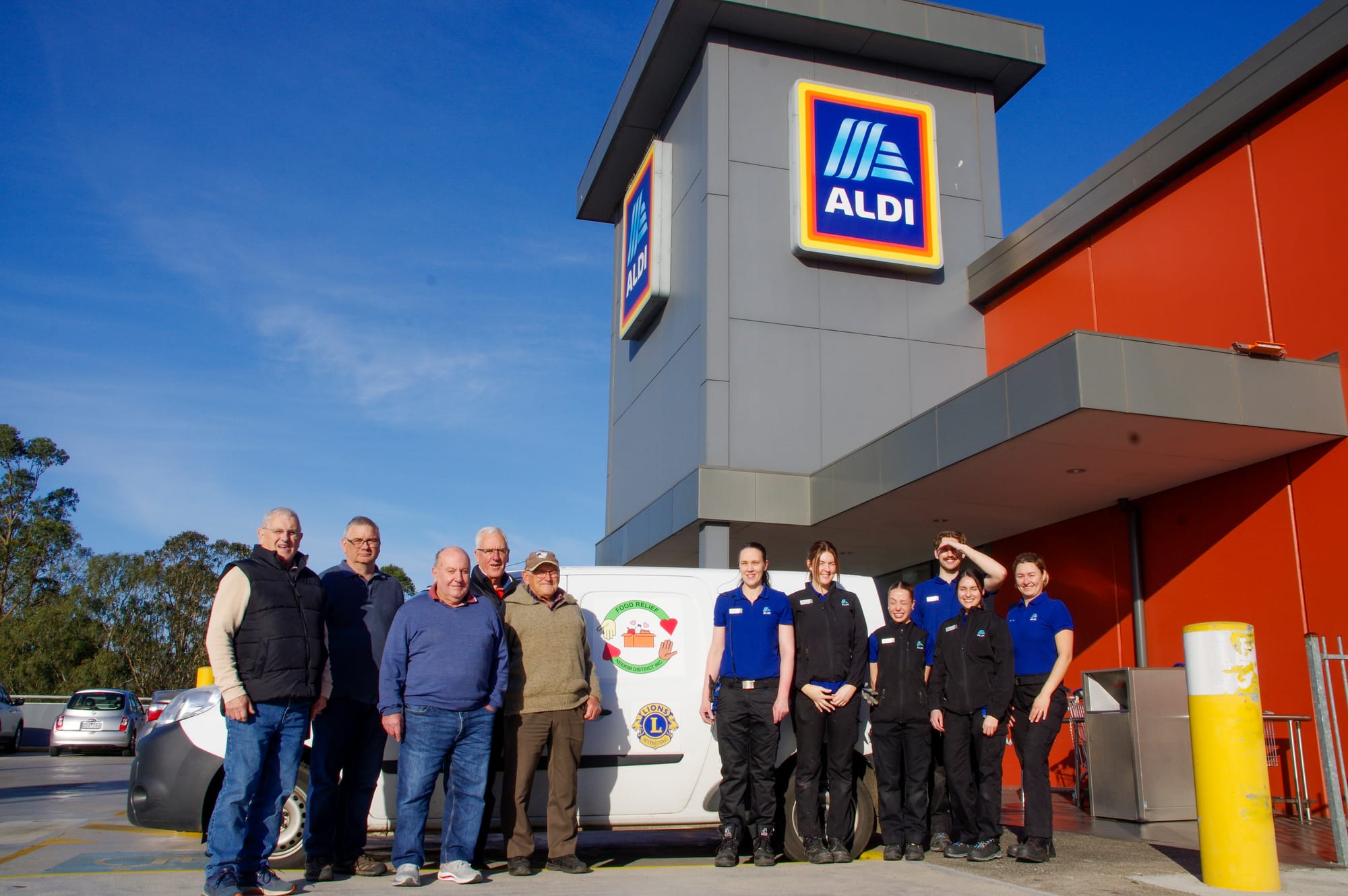 Celebrating 2000 pick-ups from Aldi Warragul are Food Relief Neerim District's Paul Lewis, David Manley-Clarke, Ian Manley, Paul Ford, John Fusinato with Aldi Warragul's Melody Kelly, Ella Mitchell, Wini Tong, Riley Pollard, Ana Alvarez and Iryna Falzon.