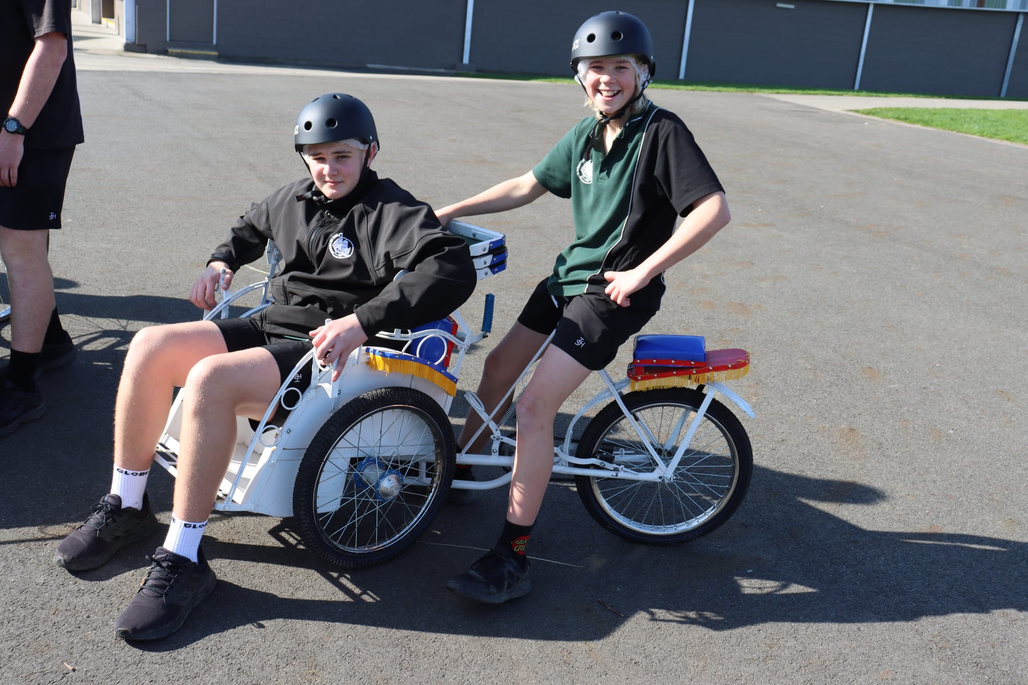 Taylor Riley treats Darcy Ashworth to a ride on one the schools Batak bikes