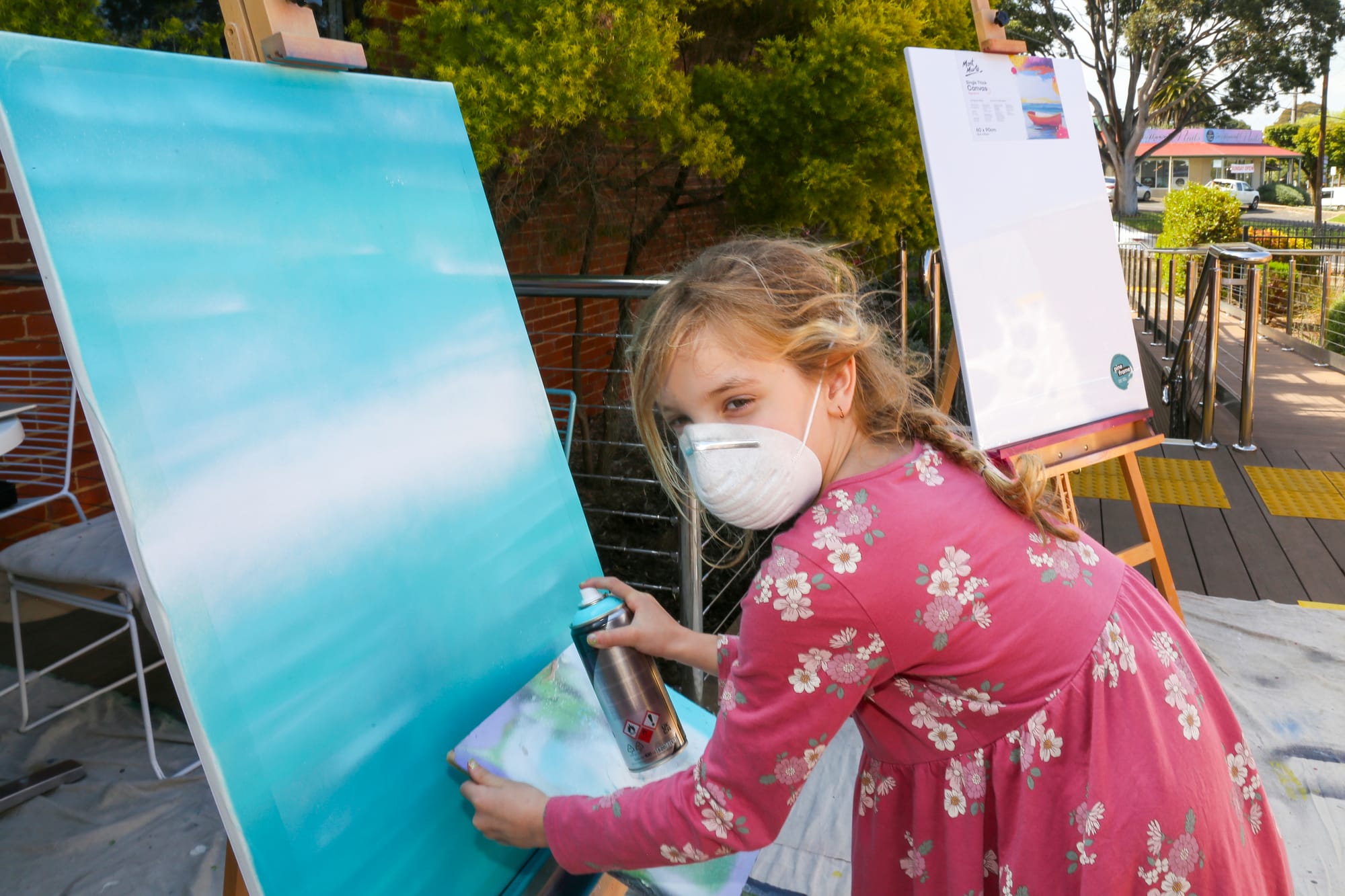 Seven-year-old Natalia Kirwin creates her aerosol masterpiece during the street art workshop in Drouin last week.