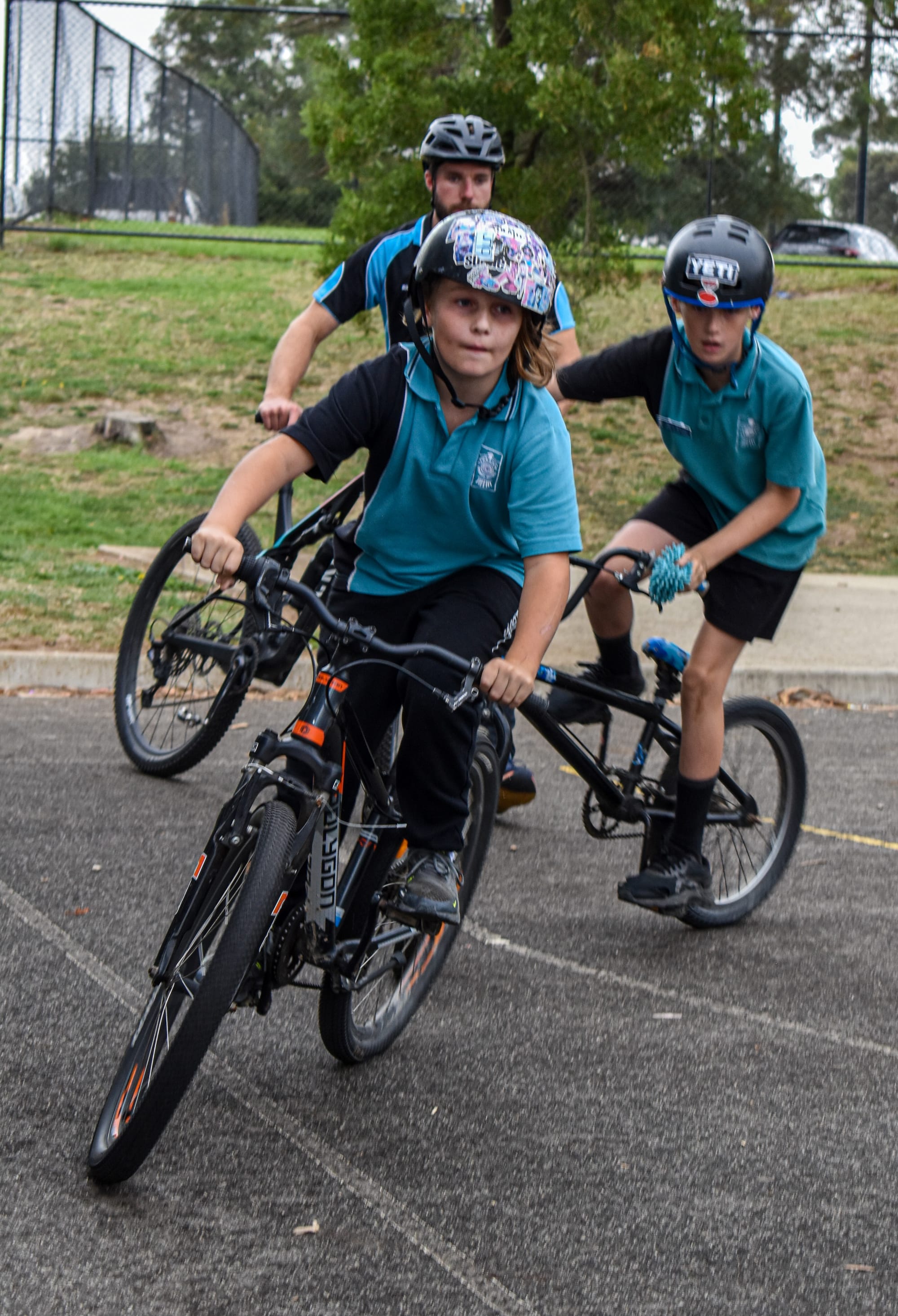 Connor Eattery and Darcy Beechy turn quickly during a biking competition.