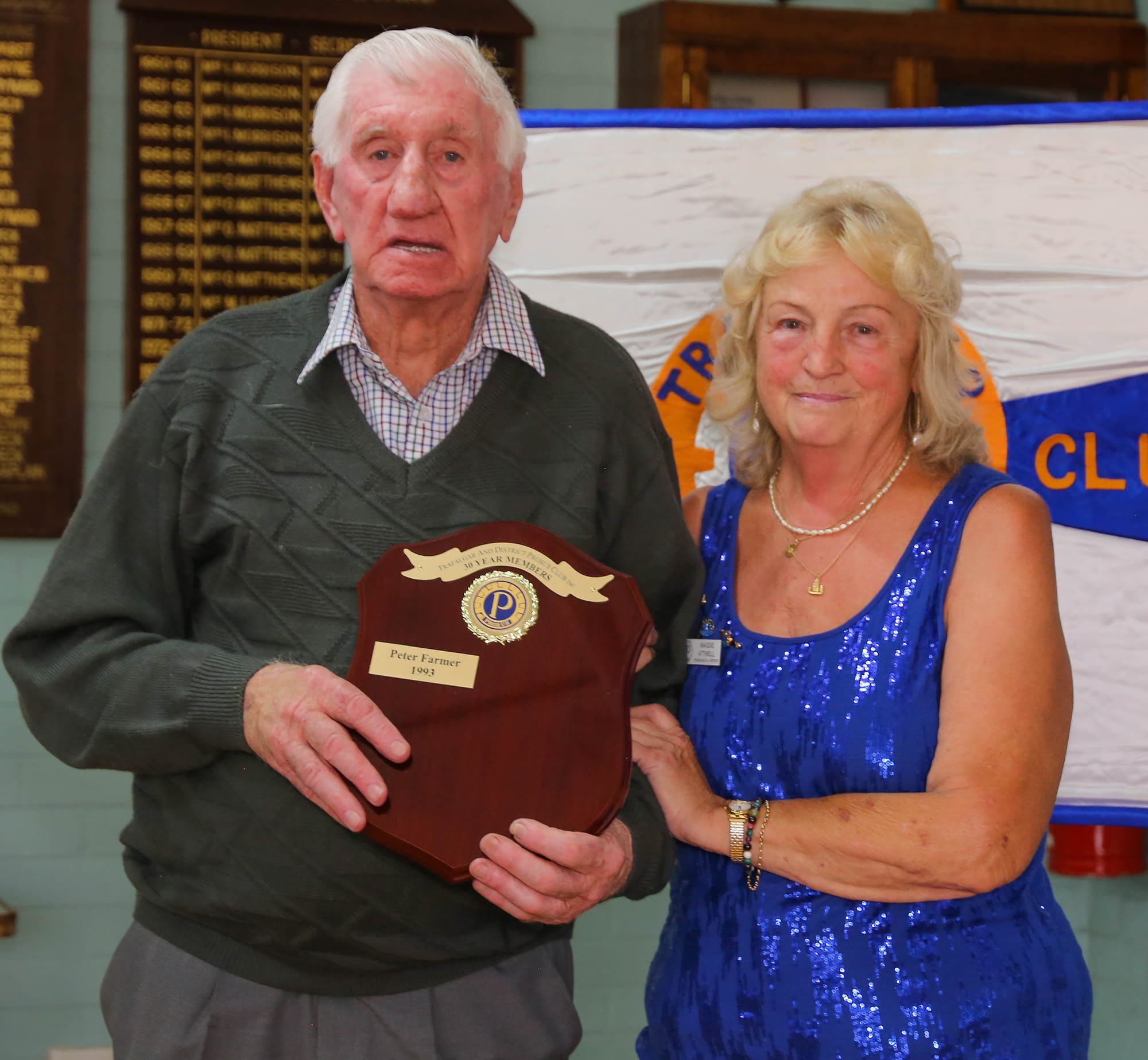 Founding member Peter Farmer is presented with a badge by president Maggie Atwell for 30 years of service.