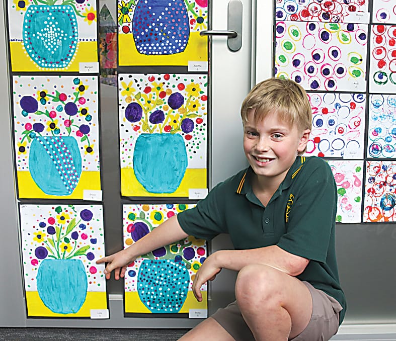 Grade five student Luke shows off his pot plant picture.